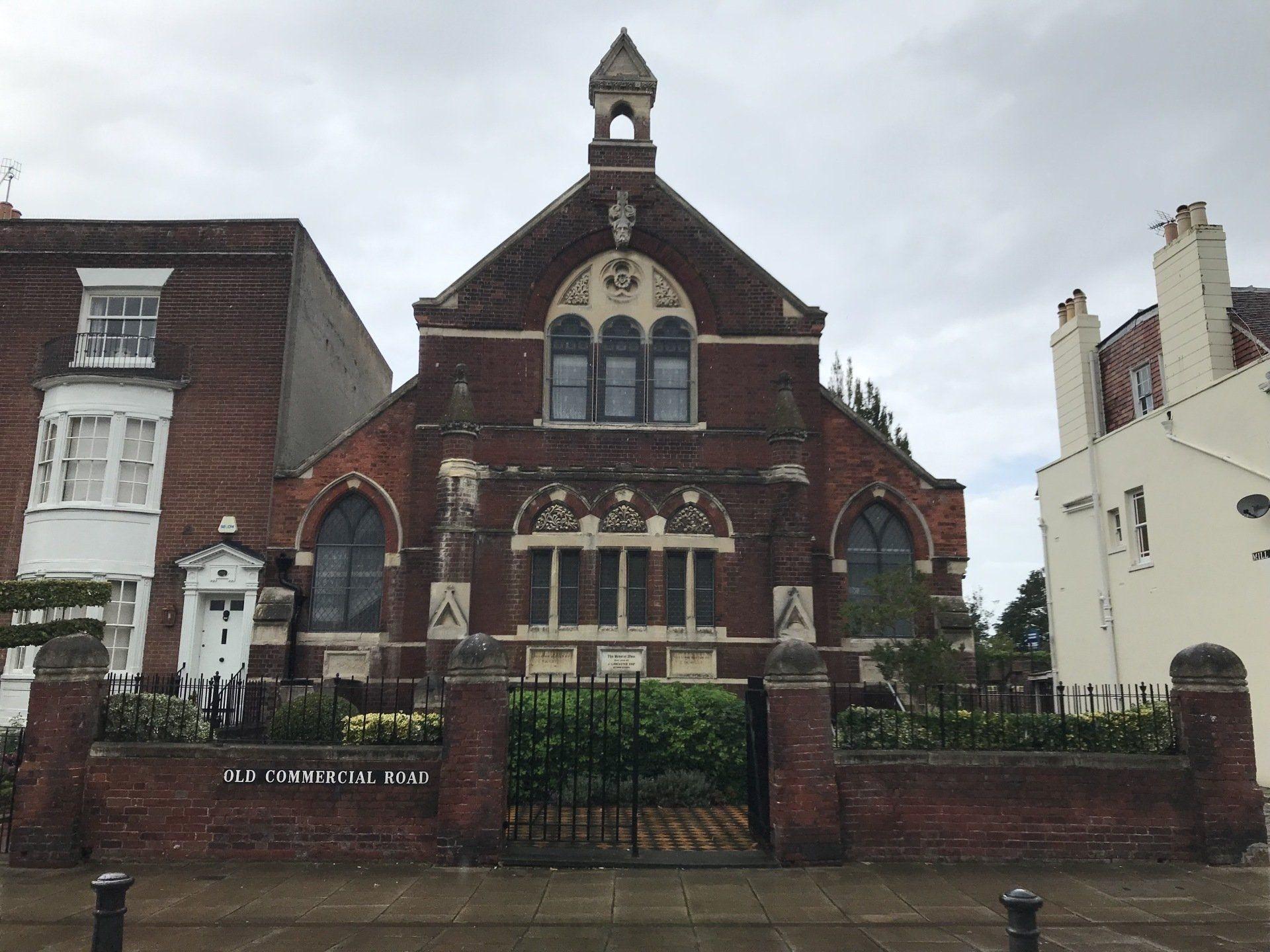 The red brick Victorian chapel on Old Commercial Road behind its iron gates