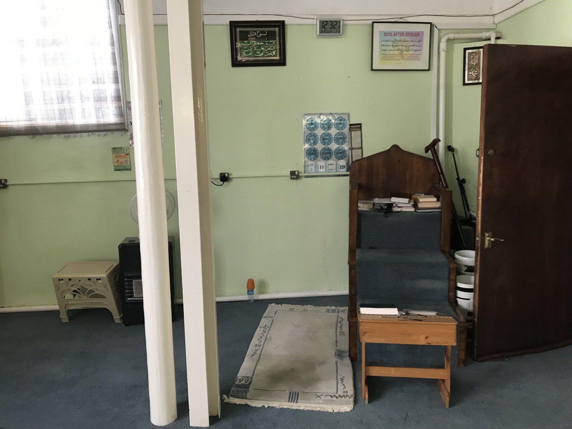 The wooden minbar beside the mihrab in the corner of the prayer hall